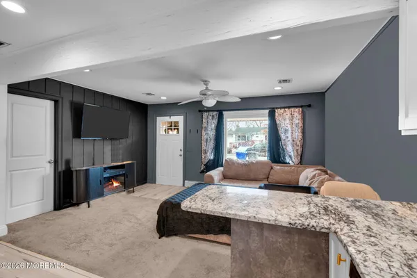 a bedroom with a large bed and a flat screen tv