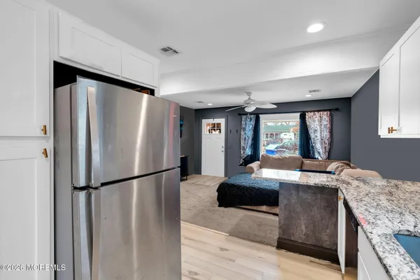 a kitchen with granite countertop a refrigerator and a sink