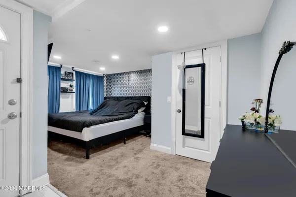 a bedroom with a bed and a couch