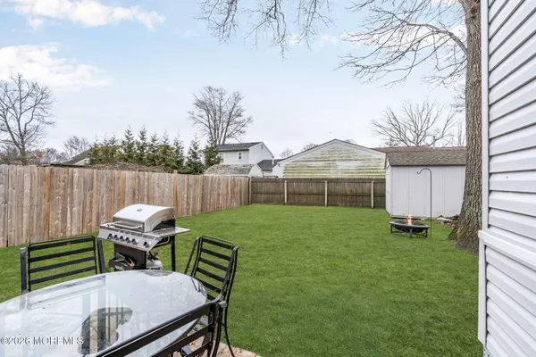 a view of a backyard with sitting area