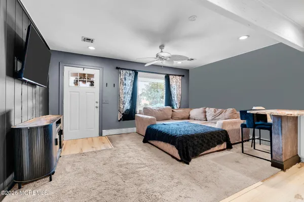a spacious bedroom with a large bed and a chandelier