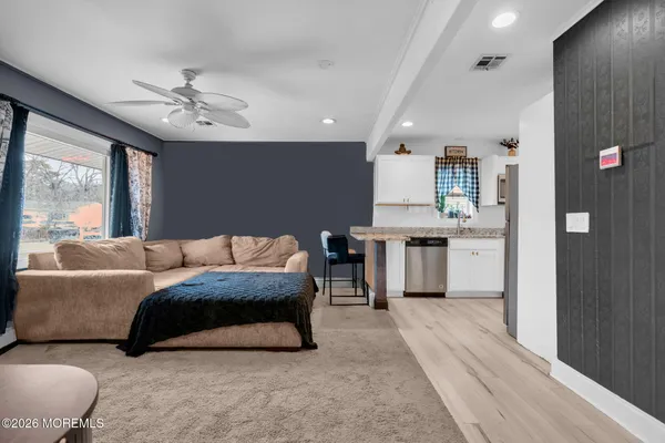 a living room with furniture and a chandelier