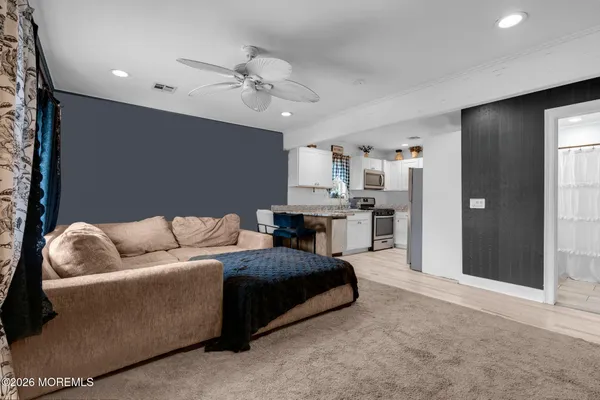 a living room with furniture and kitchen view