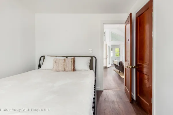 a large bed in a bedroom next to a window