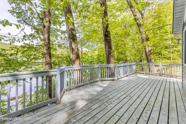a view of balcony with wooden floor and fence
