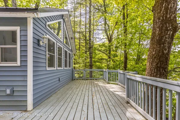 a view of a wooden deck with a yard