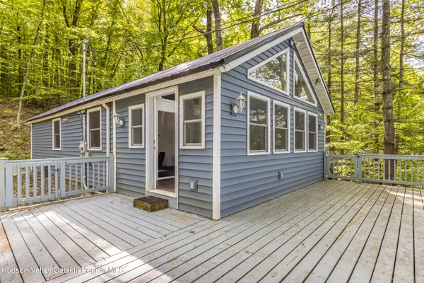 a view of a house with wooden deck and wooden floor