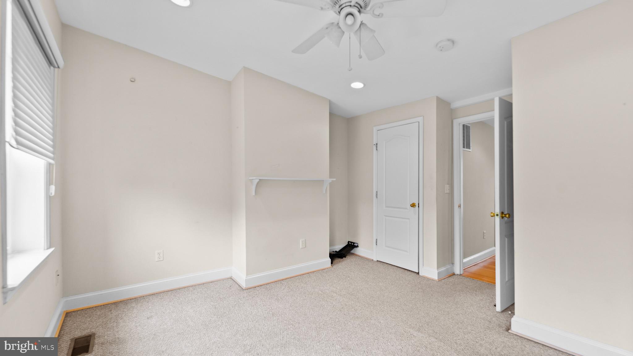628 Scott Street Baltimore, MD 21230 - Photo 17 of 33 an empty room with a ceiling fan and a window