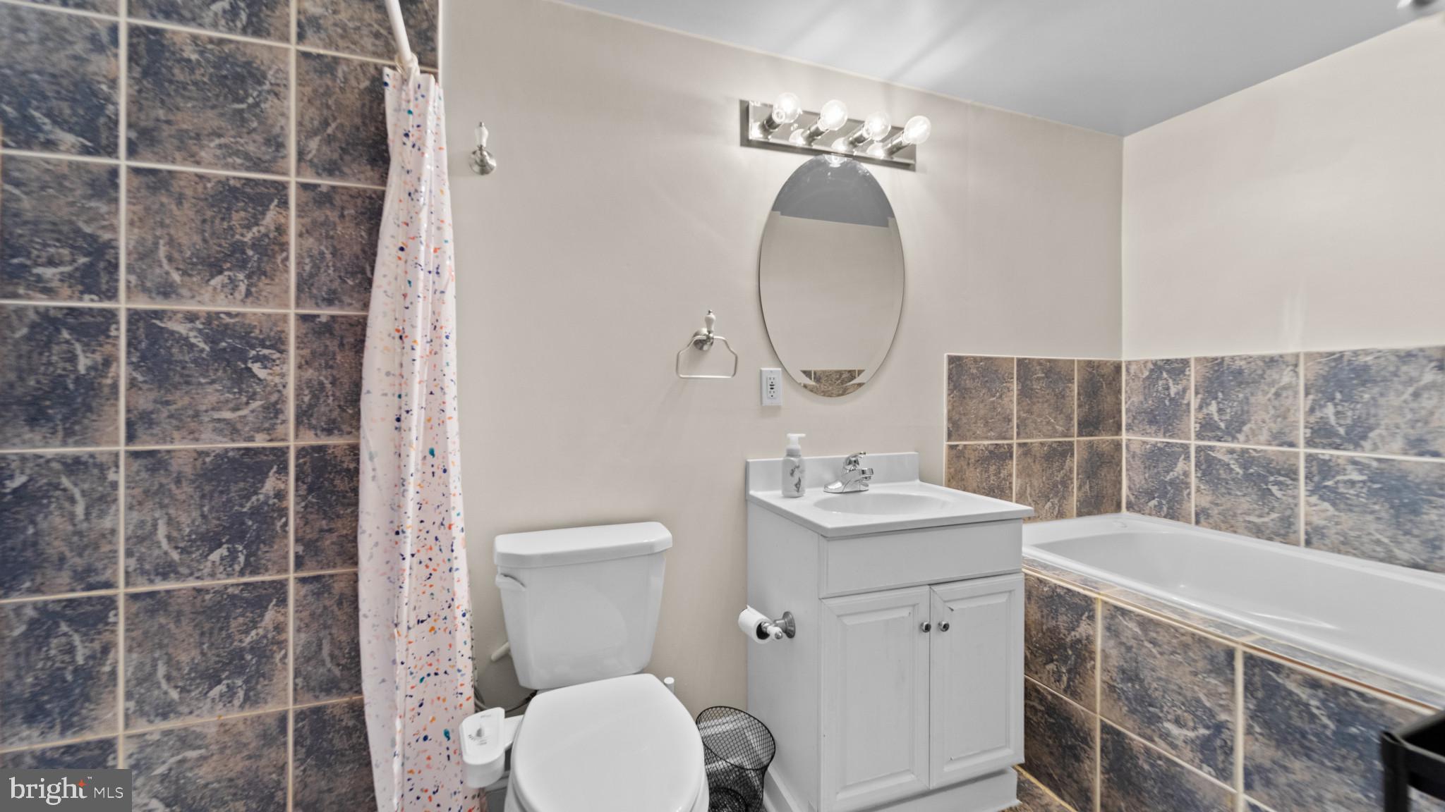 628 Scott Street Baltimore, MD 21230 - Photo 18 of 33 a bathroom with a sink a toilet and shower