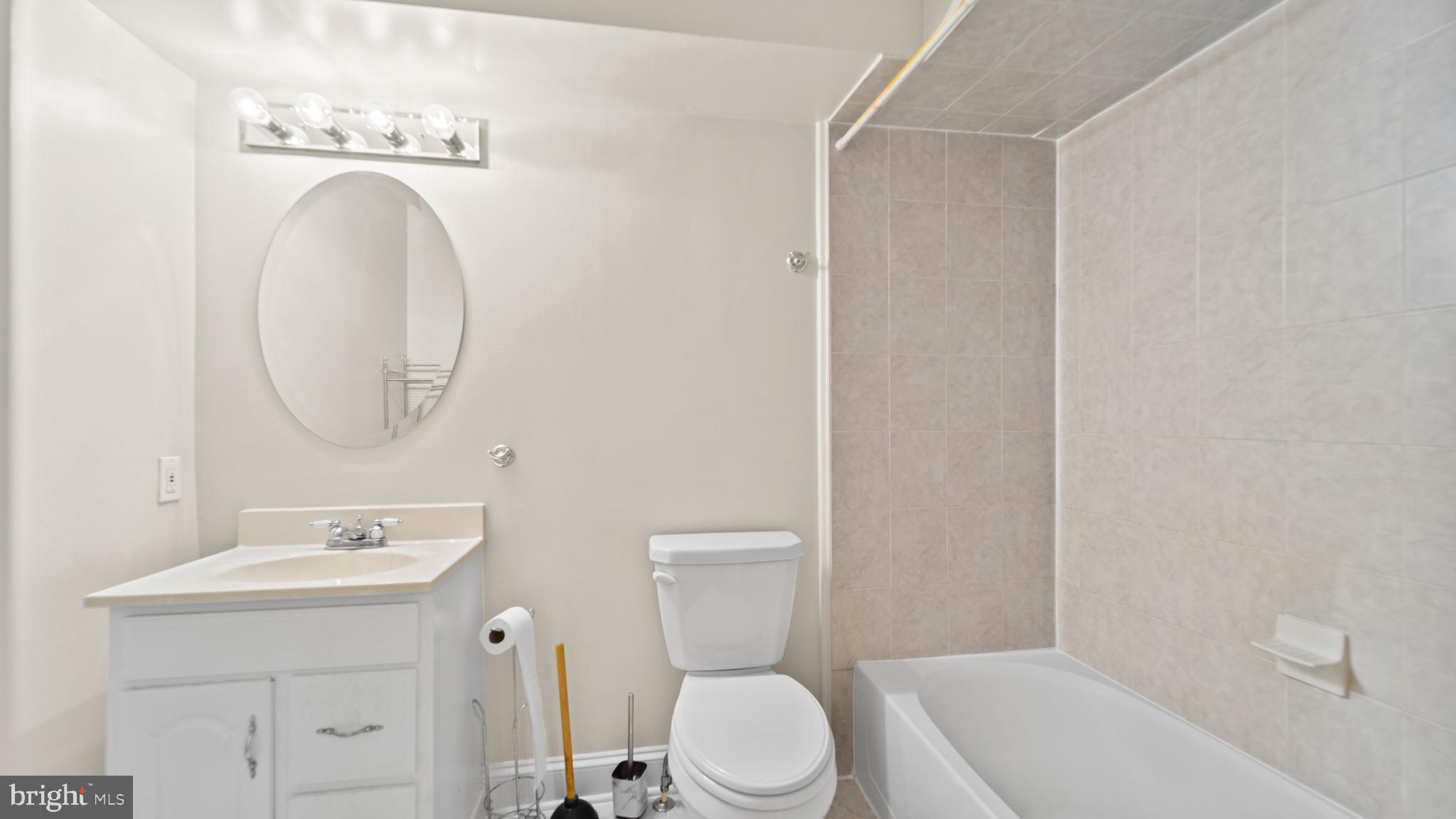 628 Scott Street Baltimore, MD 21230 - Photo 20 of 33 a bathroom with a toilet sink and mirror