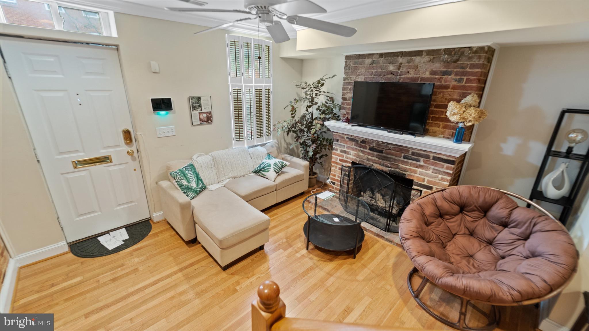 628 Scott Street Baltimore, MD 21230 - Photo 2 of 33 a living room with furniture a fireplace and a flat screen tv