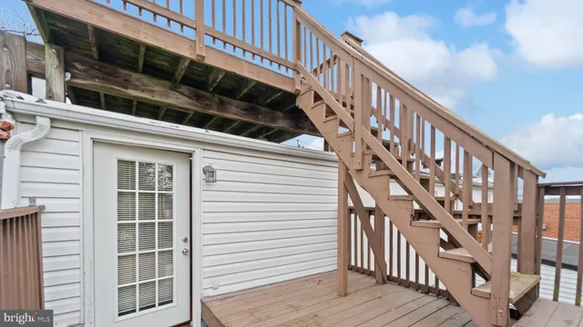 a view of entryway with wooden floor and stairs