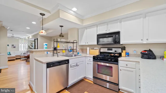 a kitchen with a sink a stove and cabinets
