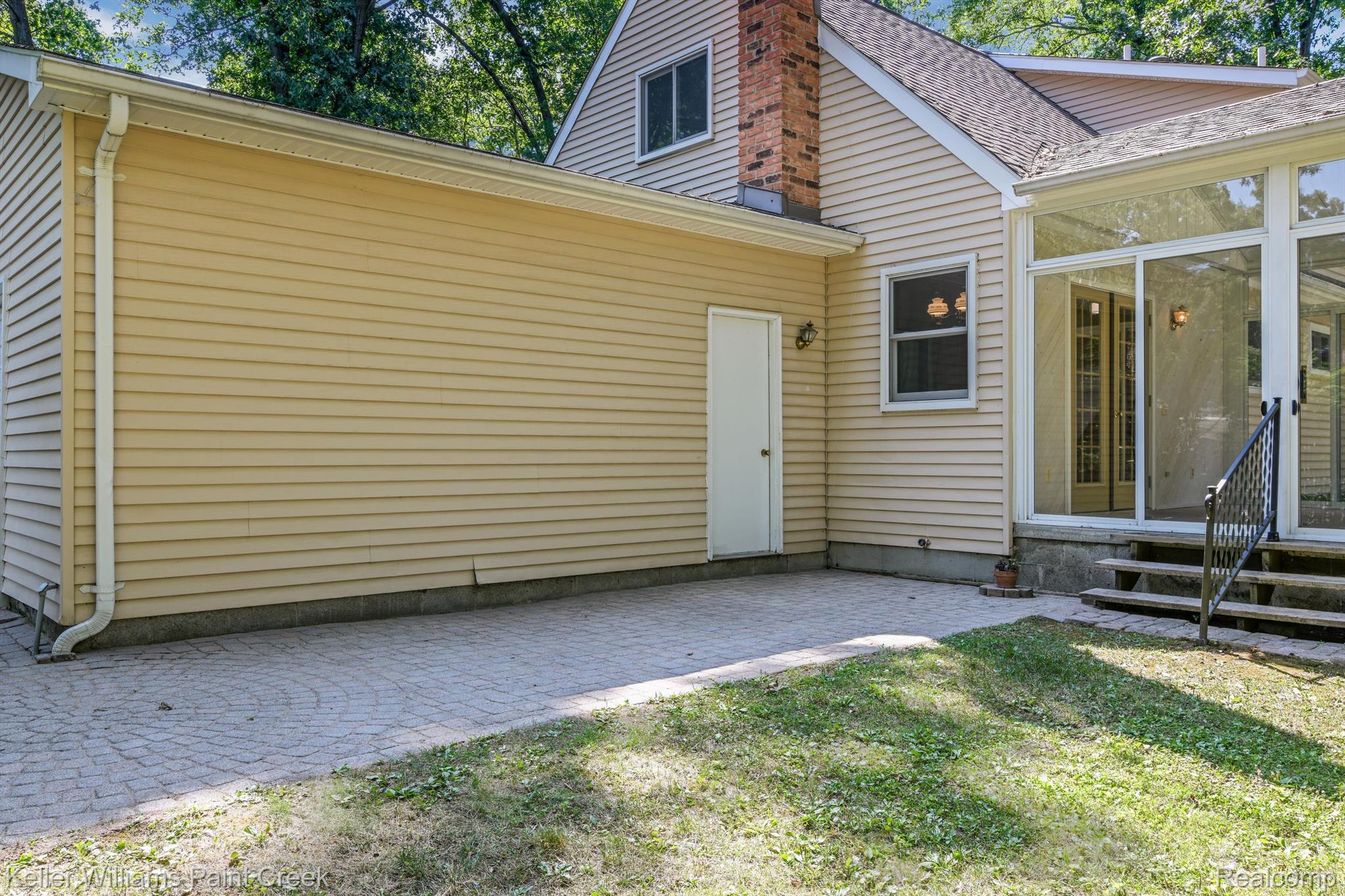 3560 Rohr Road Lake Orion, MI 48359 - Photo 18 of 22 There is a large patio with a wooded view.