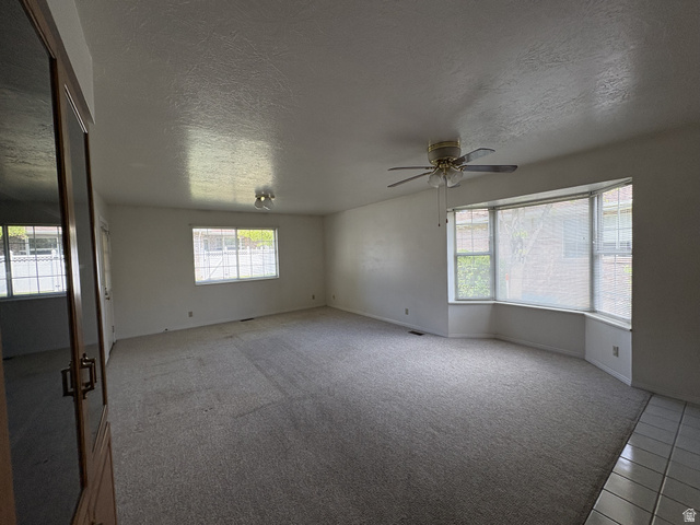 486 West 120 North Orem, UT 84057 - Photo 6 of 30 Spacious interior room featuring a large bay window, light gray carpet, and white walls