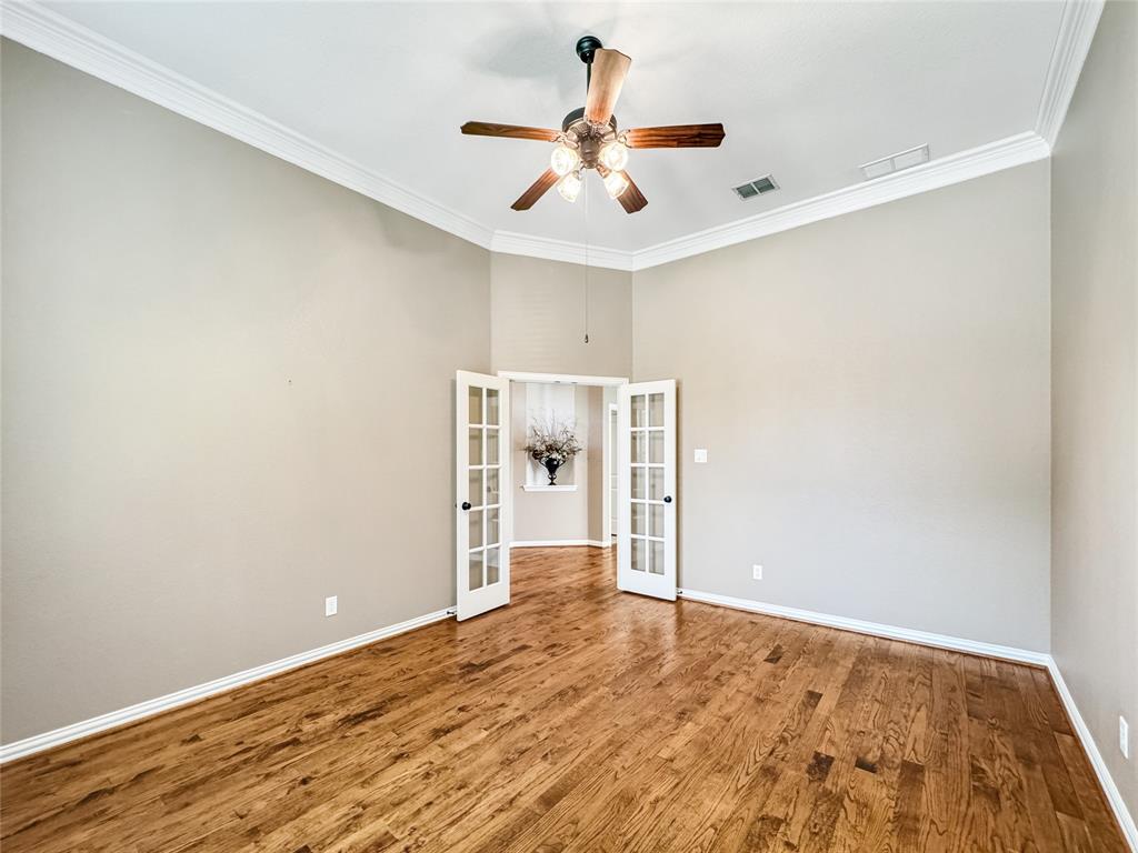 401 Varnum Way Fairview, TX 75069 - Photo 13 of 33 an empty room with wooden floor and ceiling fan