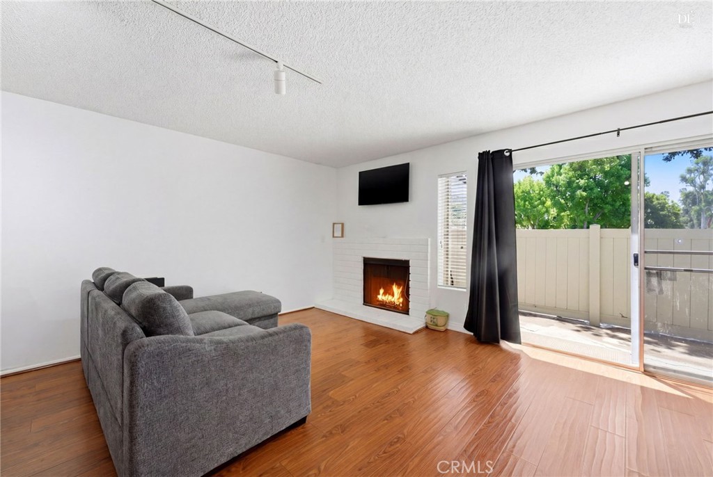 23721 Highland Valley Road Diamond Bar, CA 91765 - Photo 7 of 60 Glowing fireplace (Disclaimer: Some images have been digitally enhanced to illustrate potential room layouts and furnishings. Actual property condition and features may vary. Buyer to verify all information independently).