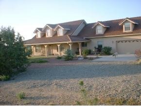 17300 Crossroads Ranch Road, Unit 63B Prescott, AZ 86305 - Photo 1 of 8 a front view of a house with a yard