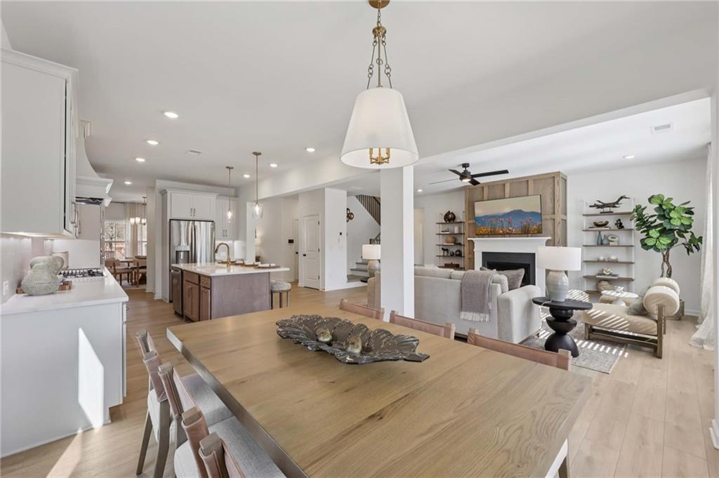6205 Kismet Road Buford, GA 30518 - Photo 12 of 43 a large kitchen with sink a refrigerator and chairs