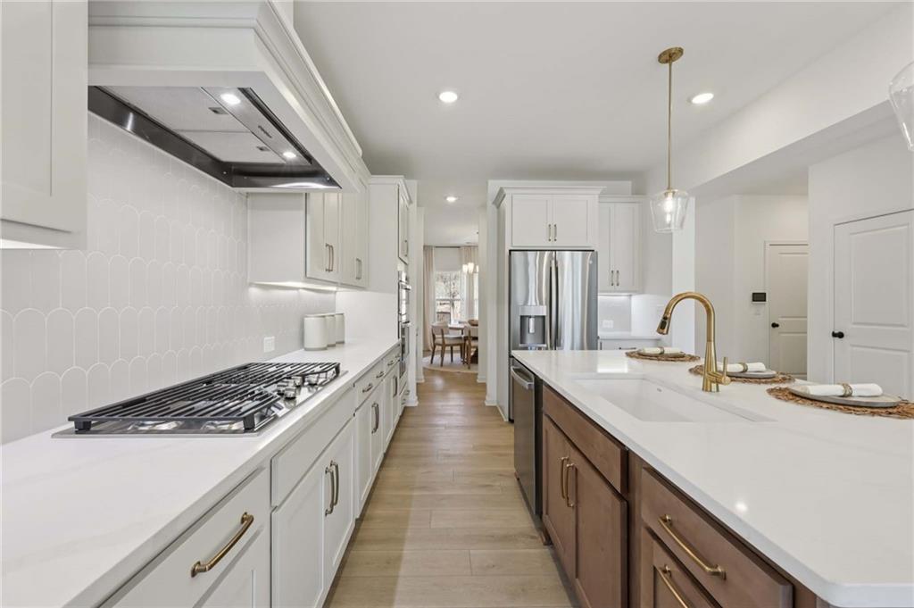 6205 Kismet Road Buford, GA 30518 - Photo 15 of 43 a kitchen with a sink stove and cabinets
