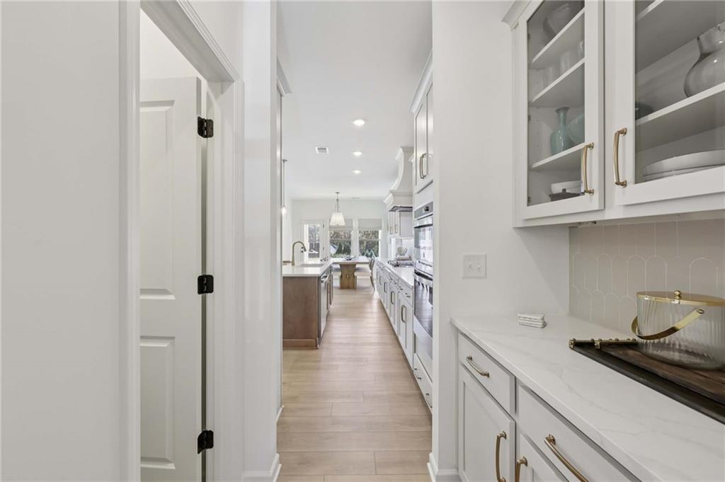 6205 Kismet Road Buford, GA 30518 - Photo 17 of 43 a kitchen with stainless steel appliances granite countertop lots of counter top space and wooden floor