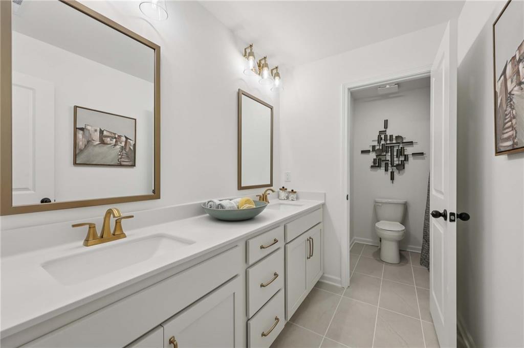 6205 Kismet Road Buford, GA 30518 - Photo 26 of 43 a bathroom with a granite countertop sink toilet and mirror