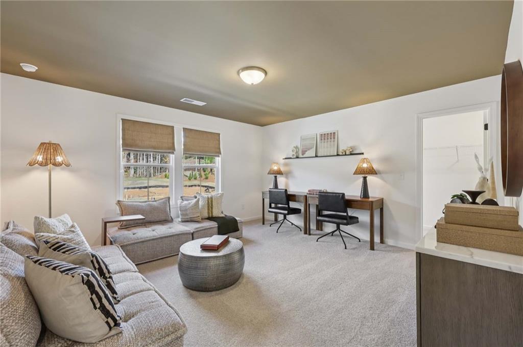 6205 Kismet Road Buford, GA 30518 - Photo 28 of 43 a living room with furniture and a table