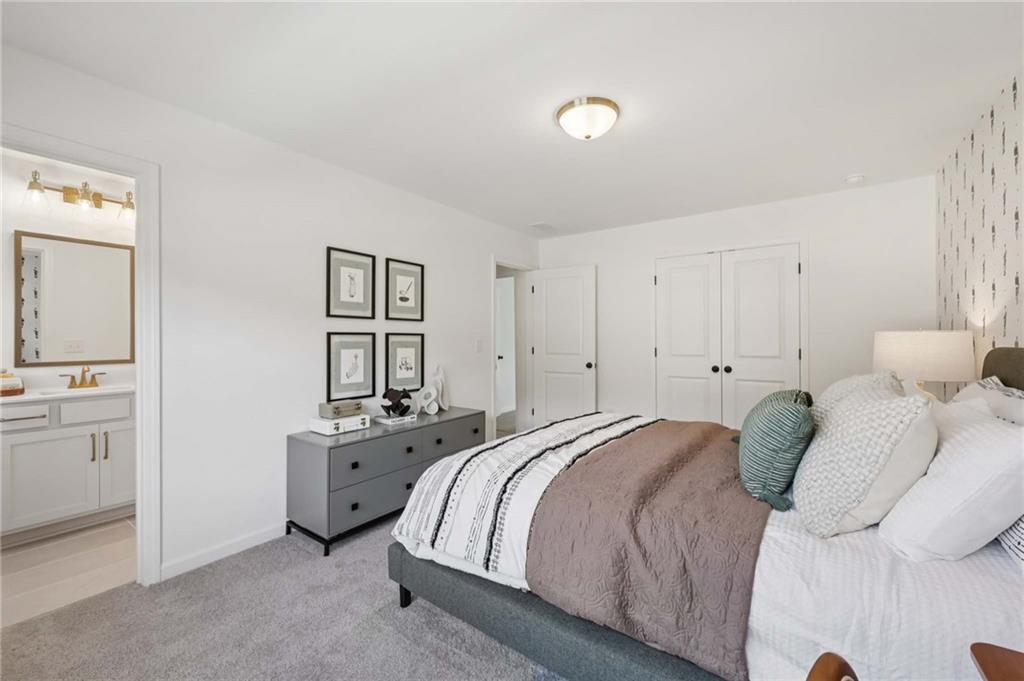 6205 Kismet Road Buford, GA 30518 - Photo 31 of 43 a bedroom with a bed and a cabinets