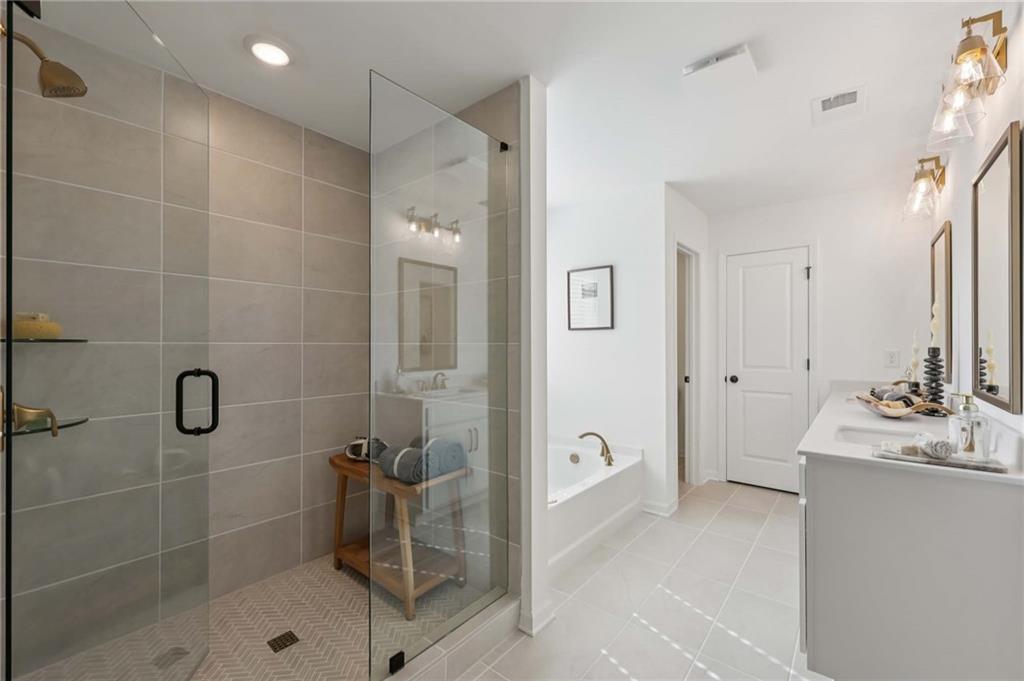 6205 Kismet Road Buford, GA 30518 - Photo 38 of 43 a bathroom with a shower sink and mirror