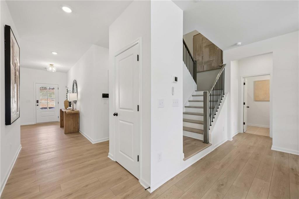 6205 Kismet Road Buford, GA 30518 - Photo 4 of 43 a view of a hallway with wooden floor and staircase