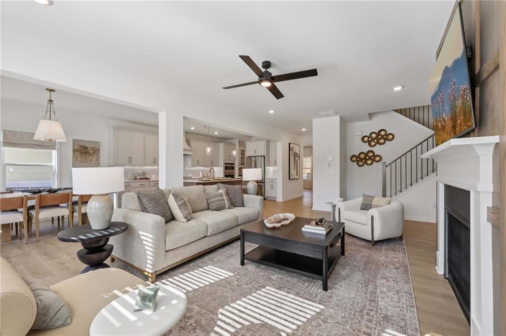 6205 Kismet Road Buford, GA 30518 - Photo 6 of 43 a living room with furniture and a flat screen tv