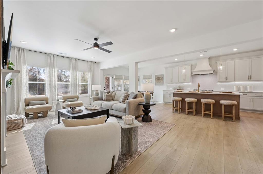 6205 Kismet Road Buford, GA 30518 - Photo 9 of 43 a living room with furniture kitchen view and a large window