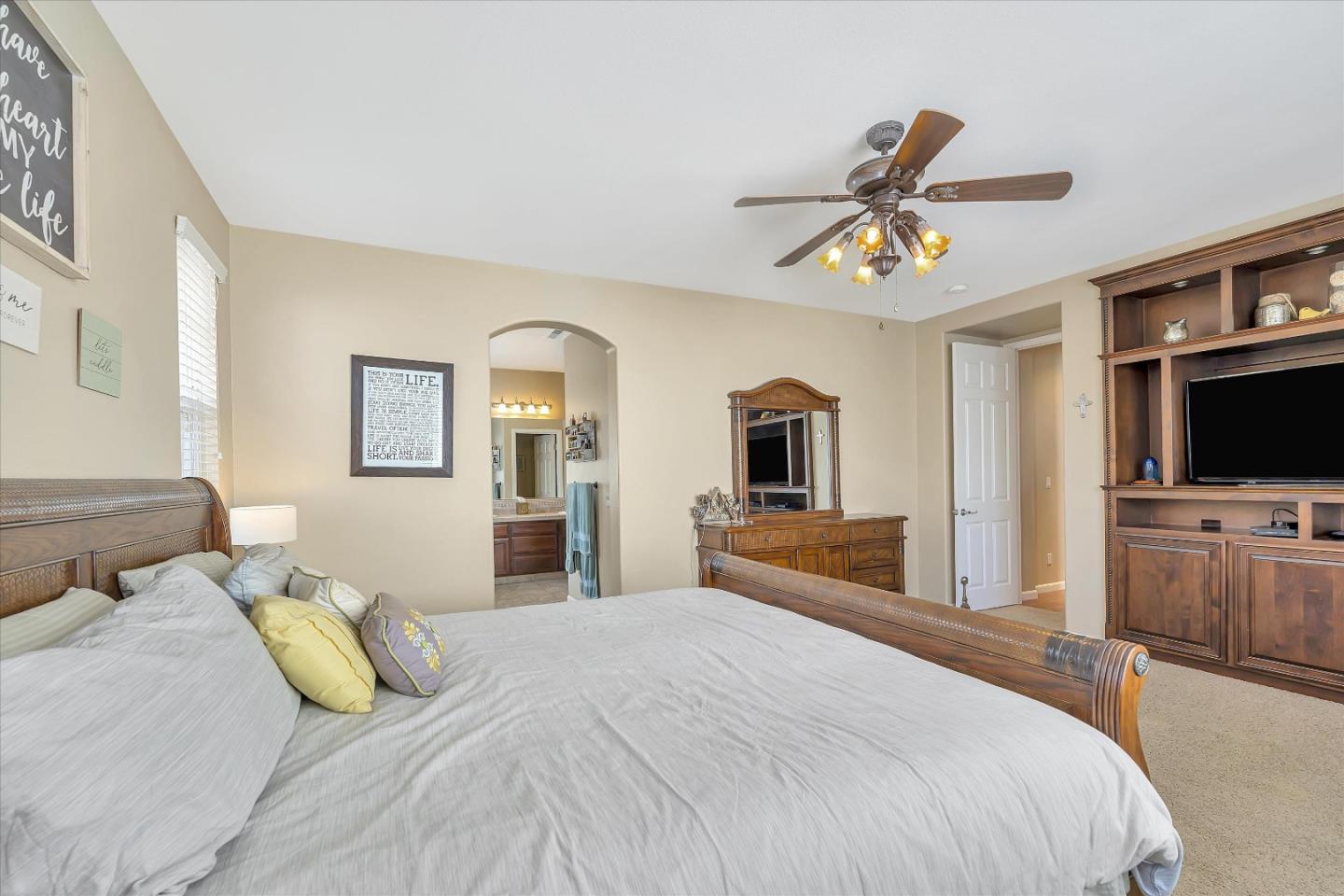 7522 Edinburgh Way Gilroy, CA 95020 - Photo 19 of 31 a bedroom with a bed and a flat screen tv