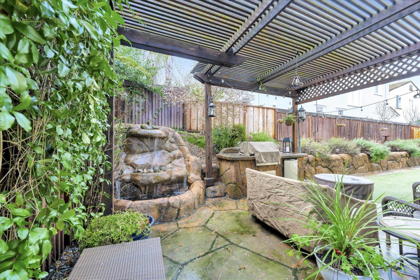 7522 Edinburgh Way Gilroy, CA 95020 - Photo 24 of 31 a view of a patio with table and chairs potted plants and large tree