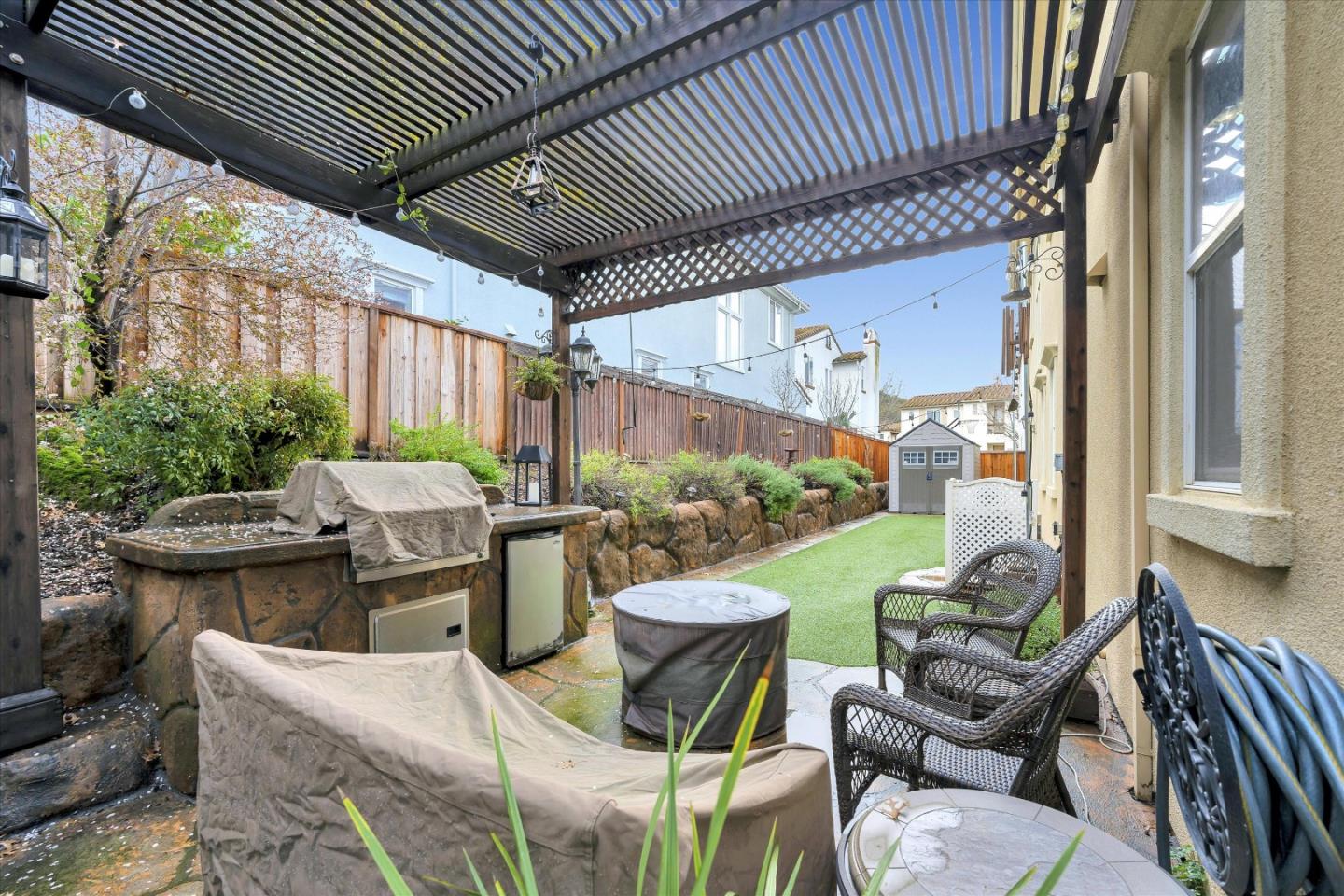 7522 Edinburgh Way Gilroy, CA 95020 - Photo 25 of 31 a view of a patio with couches table and chairs and potted plants