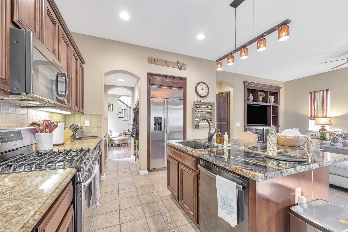 7522 Edinburgh Way Gilroy, CA 95020 - Photo 10 of 31 a kitchen with stainless steel appliances granite countertop a stove and a sink