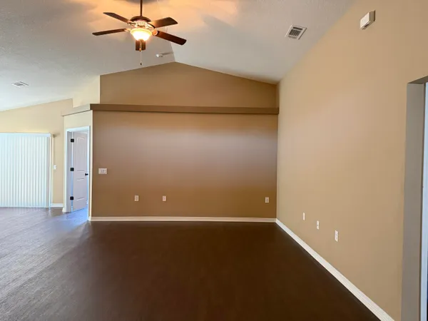 a view of a small space with wooden floor and a window