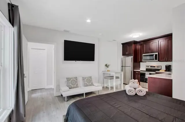 a bedroom with furniture and flat screen tv