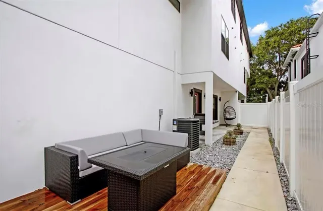 a terrace of a house with outdoor seating