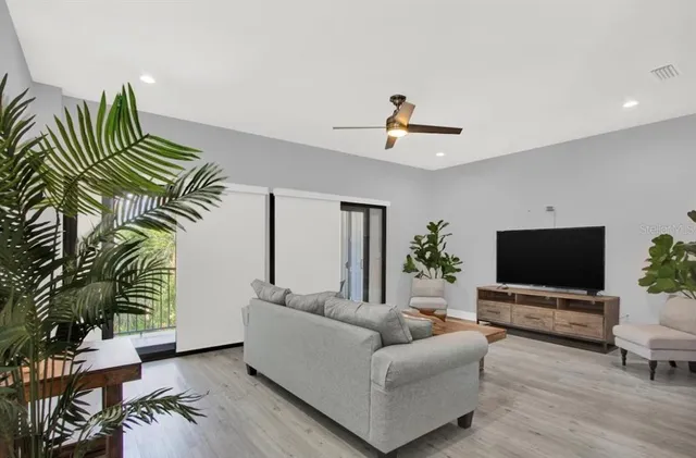 a living room with furniture and a potted plant