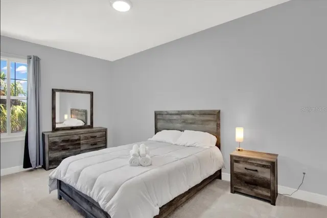 a bedroom with a bed and window