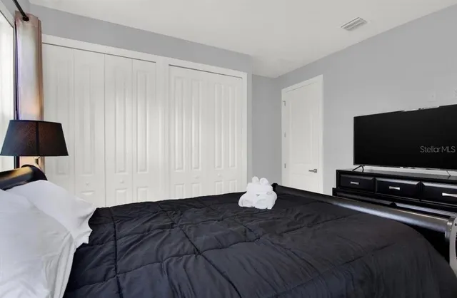 a bathroom with a granite countertop sink two mirror and a bathtub