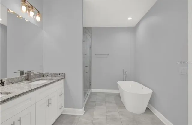 a bathroom with a granite countertop sink a toilet and a mirror
