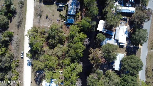 an aerial view of a house with a yard and garden