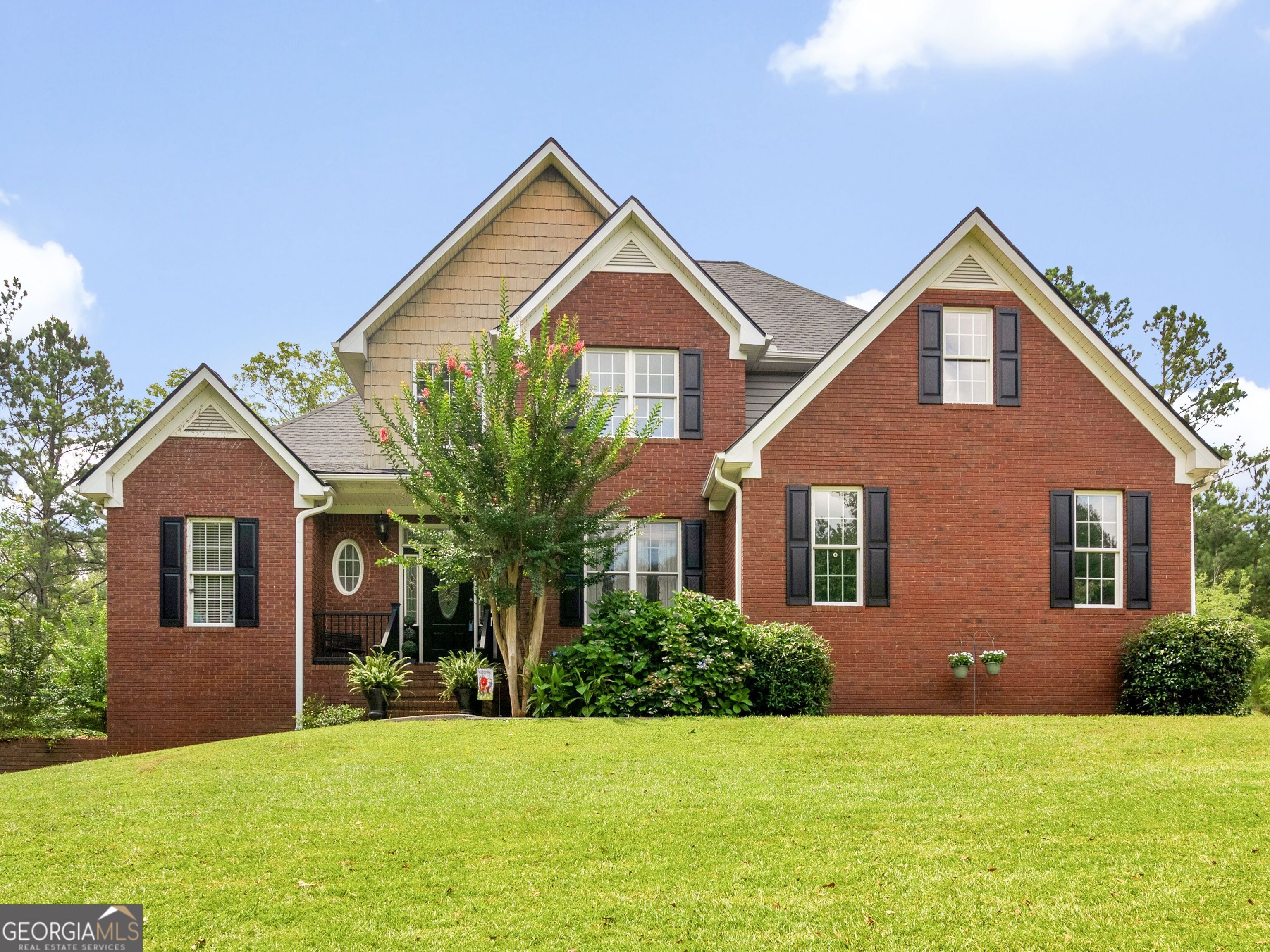 a front view of a house with a yard and garage
