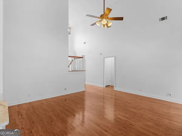 a view of empty room with wooden floor