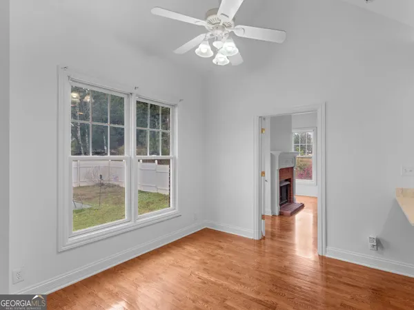 a kitchen with stainless steel appliances granite countertop a sink a stove a refrigerator a washer dryer and white cabinets