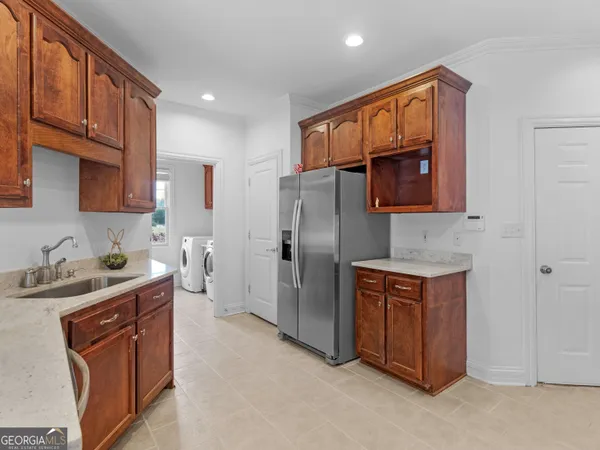 a large kitchen with a large stove top oven a sink a counter space and cabinets