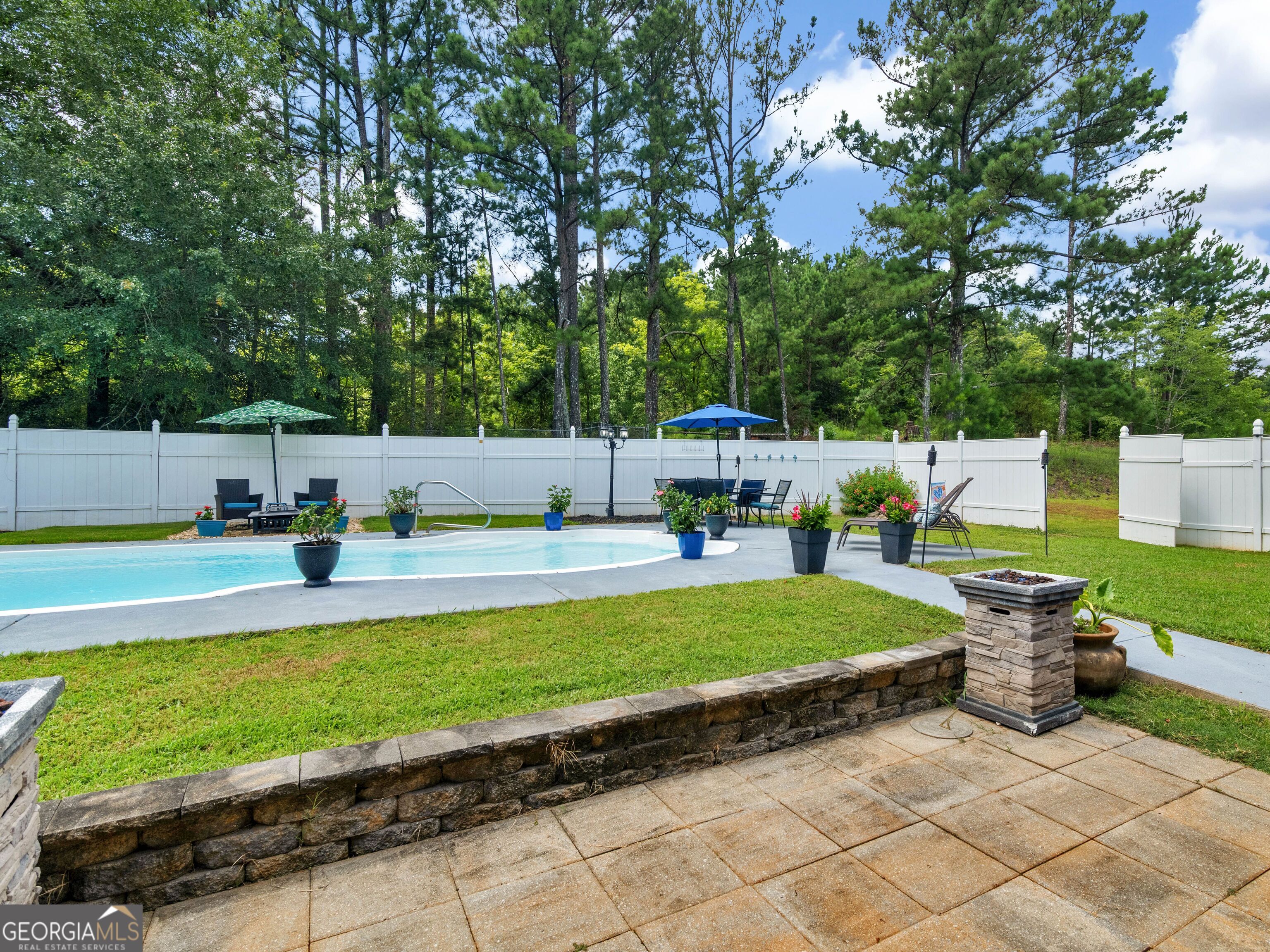 155 Rocky Way Williamson, GA 30292 - Photo 21 of 56 a view of a swimming pool with a lounge chairs