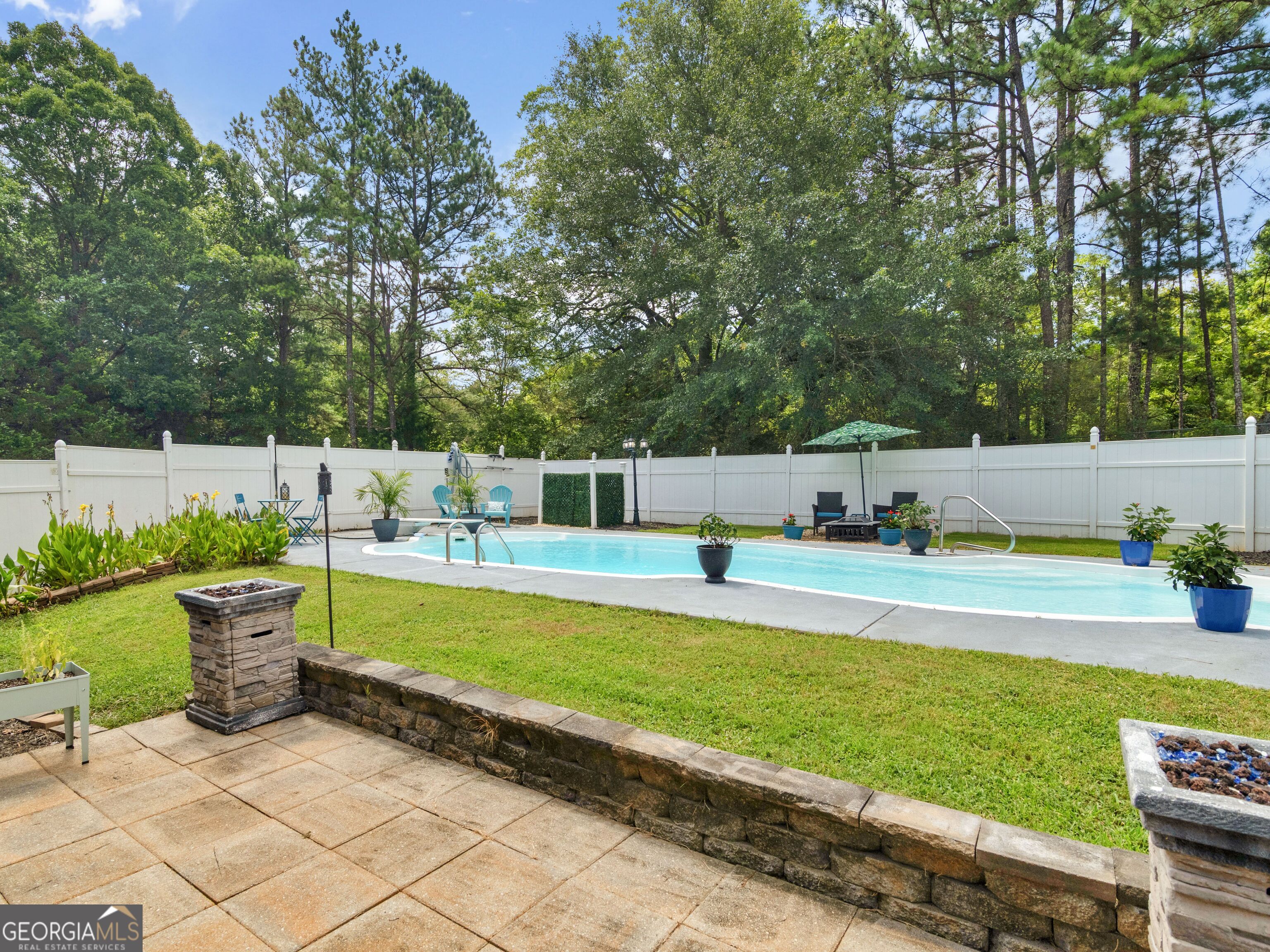 155 Rocky Way Williamson, GA 30292 - Photo 22 of 56 a view of a swimming pool with a lounge chairs